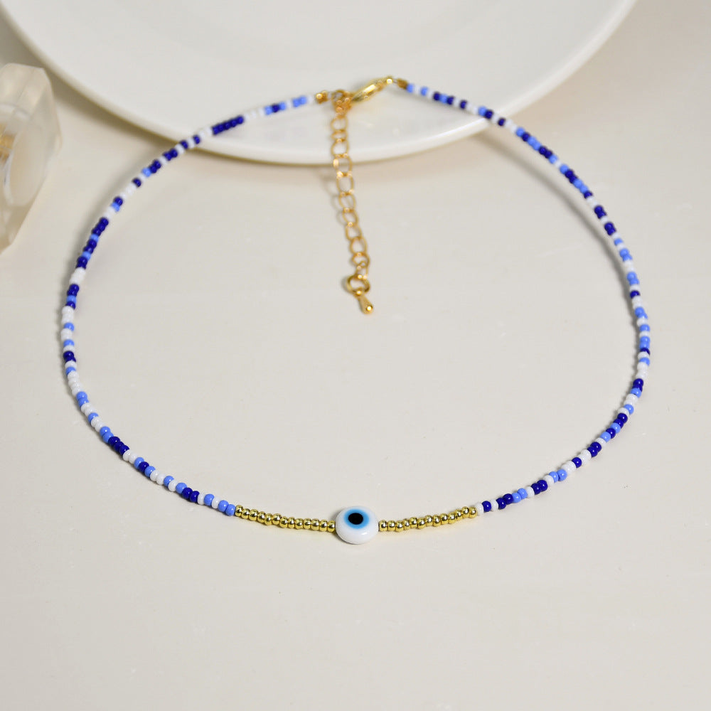 Collar de capa cruzada de perlas de arroz de ojos azules de vidrio al por mayor